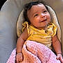 Audrina joined the competition — help win amazing prizes! baby, infant, smile, yellow_clothing, pink_blanket, bottle, curly_hair, cushion, seat, happy, cute, indoors, child, portrait, soft_texture, cozy, small_hand, young_child, looking_up, face