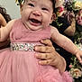 baby, child, pink_dress, flower_crown, smiling, happy, portrait, indoor, celebration, person, holding, flowers, cute, tulle, hands, face, headwear, dress, festive, joy