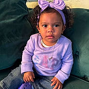 Denim is registered to the contest to win money with this photo: accessories, baby, clothing, couch, cushion, face, footwear, furniture, head, homedecor, jeans, jewelry, necklace, pants, person, photography, portrait, purple, shoe, sitting