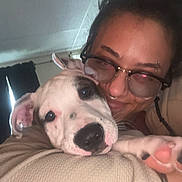 Casper joined the competition — help win amazing prizes! puppy, dog, person, cuddle, portrait, indoors, close_up, white_dog, spotted_dog, floppy_ears, sleepy, lying_down, human, glasses, nose_ring, shoulder, paw, pet, affection, home