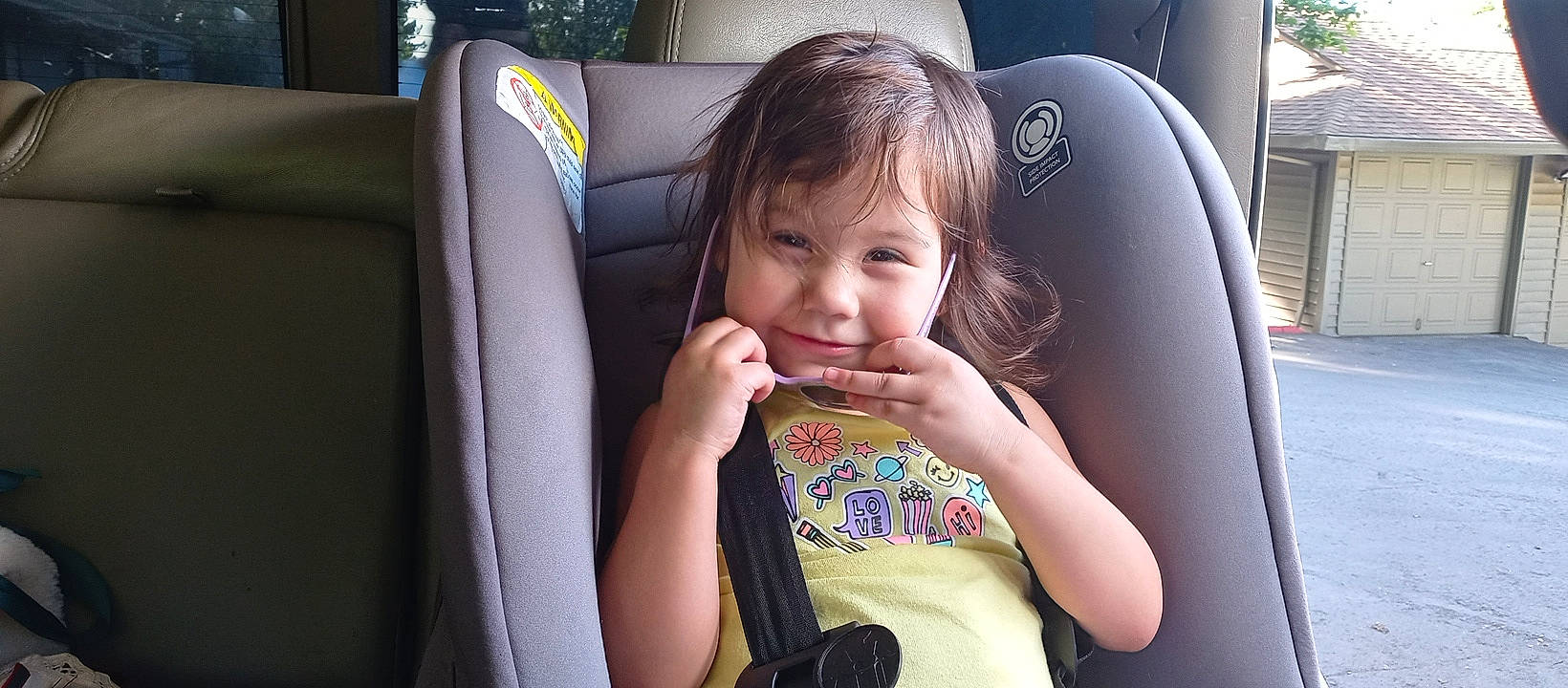 Katori is registered to the contest to win money with this photo: auto_part, car_seat, child, eye, eyelash, face, family_car, fun, gesture, happy, head, joy, leisure, mouth, person, seat_belt, sitting, skin, thumb, toddler
