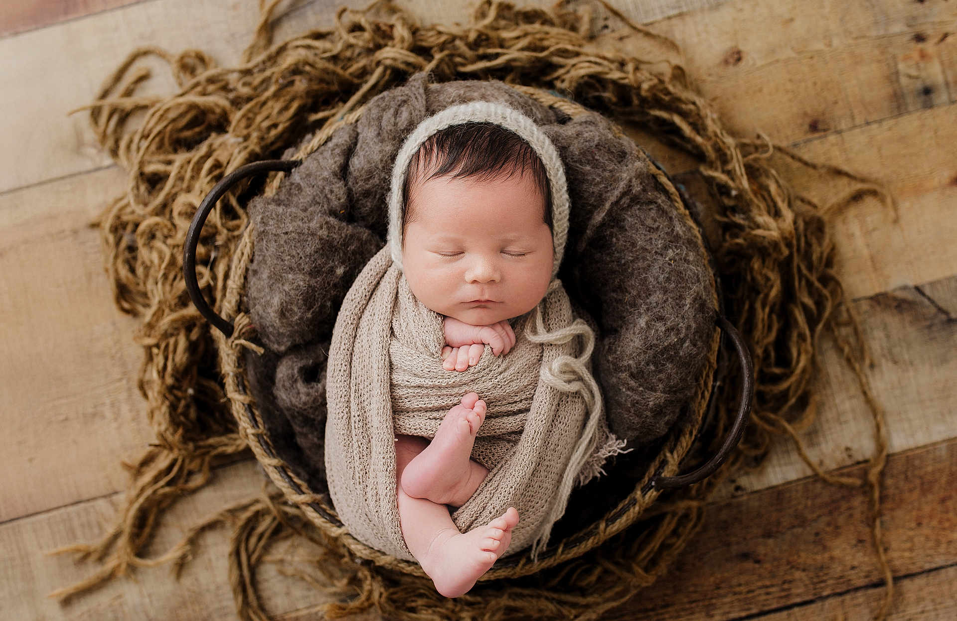 Layne is registered to the contest to win money with this photo: newborn, baby, sleeping, basket, blanket, knit, wrapped, cozy, soft, infant, peaceful, resting, wooden_floor, brown, beige, texture, cute, portrait, headwear, fingers