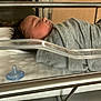 James is registered to the contest to win money with this photo: newborn, baby, sleeping, hospital, bassinet, pacifier, blanket, gray, infant, swaddled, peaceful, indoor, bed, wood, metal, healthcare, person, child, cute, quiet