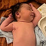 James is registered to the contest to win money with this photo: newborn, baby, sleeping, infant, umbilical_stump, blanket, soft_texture, skin, arm, head, face, peaceful, clothing, lying_down, cute, resting, child, indoors, closeup, human