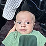 Bennett joined the competition — help win amazing prizes! baby, infant, child, green_shirt, car_interior, steering_wheel, ford_logo, hand, white_cloth, shadow, portrait, close_up, seat, sunlight, window, face, eyes, skin, person, casual_clothing