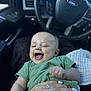 Bennett is registered to the contest to win money with this photo: baby, infant, smiling, laughing, green_shirt, car_interior, steering_wheel, blanket, hand, person, cute, happy, portrait, child, seat, clothing, toddler, human, car, seatbelt