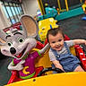 amusement, cartoon_character, child, childhood, colorful, cute, entertainment, fun, happy, indoor, kiddie_ride, mouse, overalls, play_area, seat, short_sleeve_shirt, smiling, toddler, toy_car, young_child