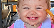 Mikayla joined the competition — help win amazing prizes! toddler, child, smiling, happy, face, food, french_fries, grilled_cheese, plate, table, bib, indoor, messy, hands, meal, cute, eating, portrait, person, dining