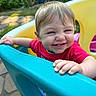 Mikayla is registered to the contest to win money with this photo: toddler, child, smile, playground, plastic, outdoor, daylight, garden, pool, colorful, happy, face, hand, clothing, red_shirt, blue, yellow, green, nature, fun