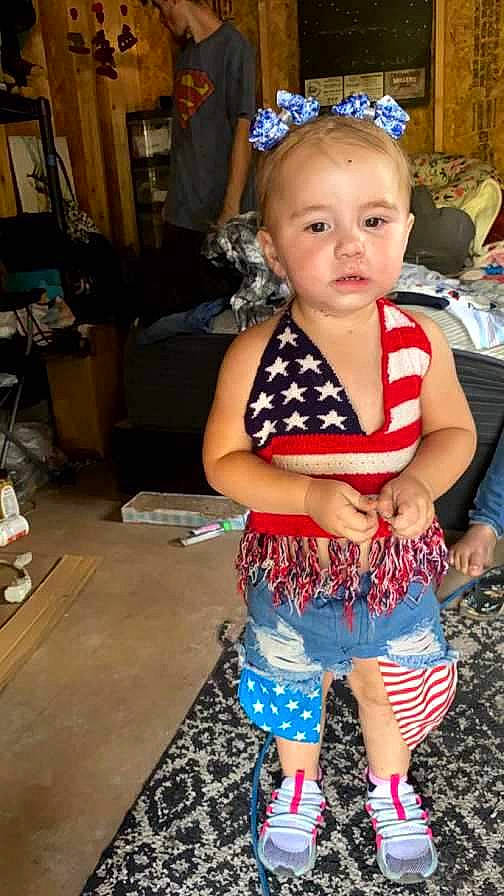 Laela is registered to the contest to win money with this photo: baby, baby_toddler_clothing, chair, child, electric_blue, event, eye, fashion_accessory, fun, hairstyle, happy, head, human_leg, party, pattern, person, sandal, shorts, sitting, thigh