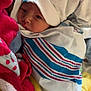 Baylor is registered to the contest to win money with this photo: newborn, baby, blanket, hospital, wrapped, sleepy, hat, face, child, soft, cozy, fabric, striped, red, yellow, blue, white, infant, cute, portrait