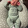 Baylor is registered to the contest to win money with this photo: baby, newborn, sleeping, infant, onesie, clothing, pillow, cushion, pattern, white, green, face, hands, feet, sock, indoor, soft, peaceful, resting, person