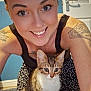 Luna joined the competition — help win amazing prizes! animal, black_tank_top, blue_wall, carpet, cat, closeup, door, eyes, face, floor, furniture, happy, indoor, kitten, patterned_skirt, pets, smiling, tattoos, woman, young_adult