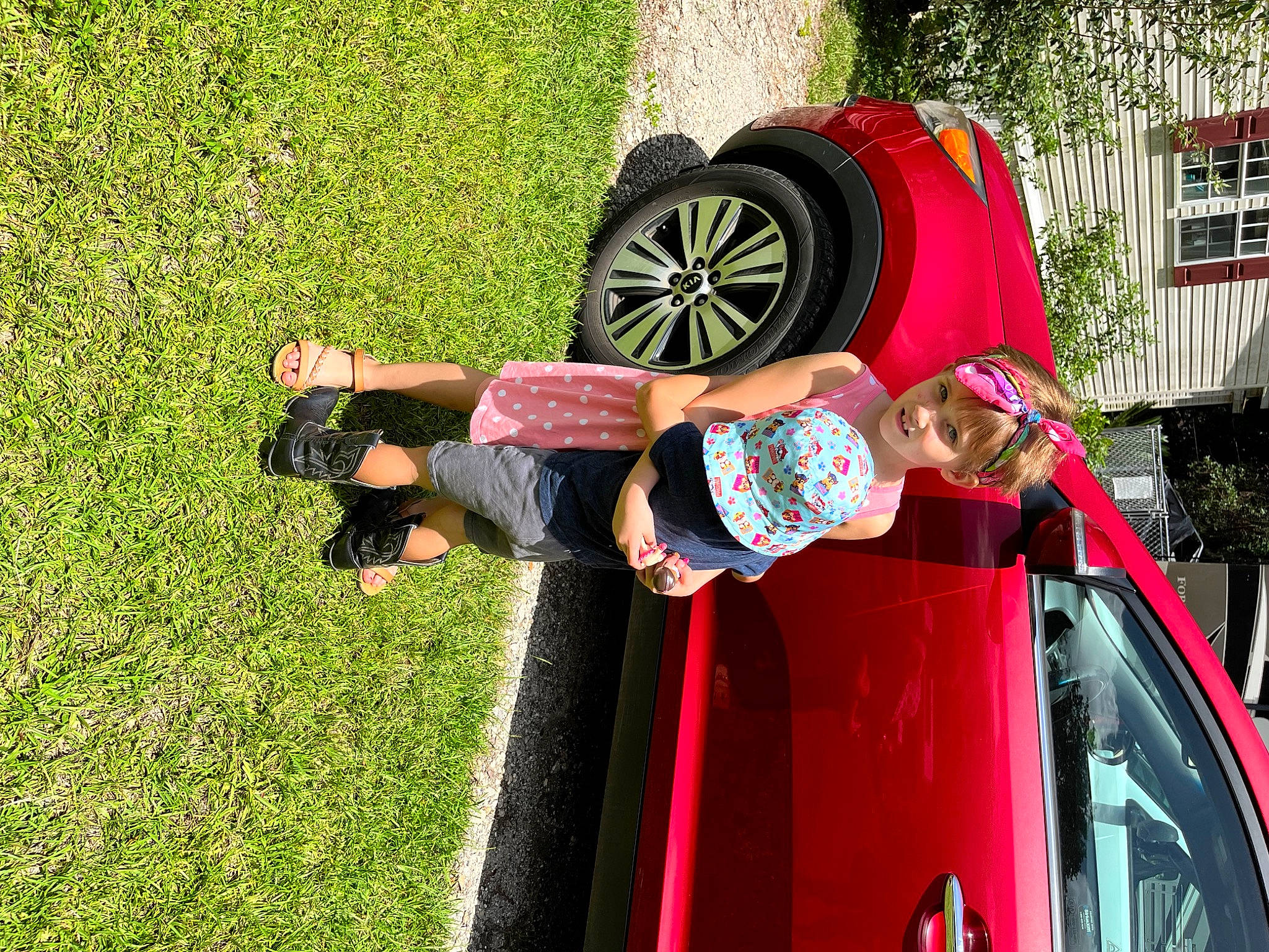 Annabel joined the competition — help win amazing prizes! auto_part, automotive_design, automotive_exterior, automotive_lighting, automotive_tire, automotive_wheel_system, car, fun, grass, headwear, joy, leisure, motor_vehicle, people_in_nature, person, plant, red, tire, toddler, tree