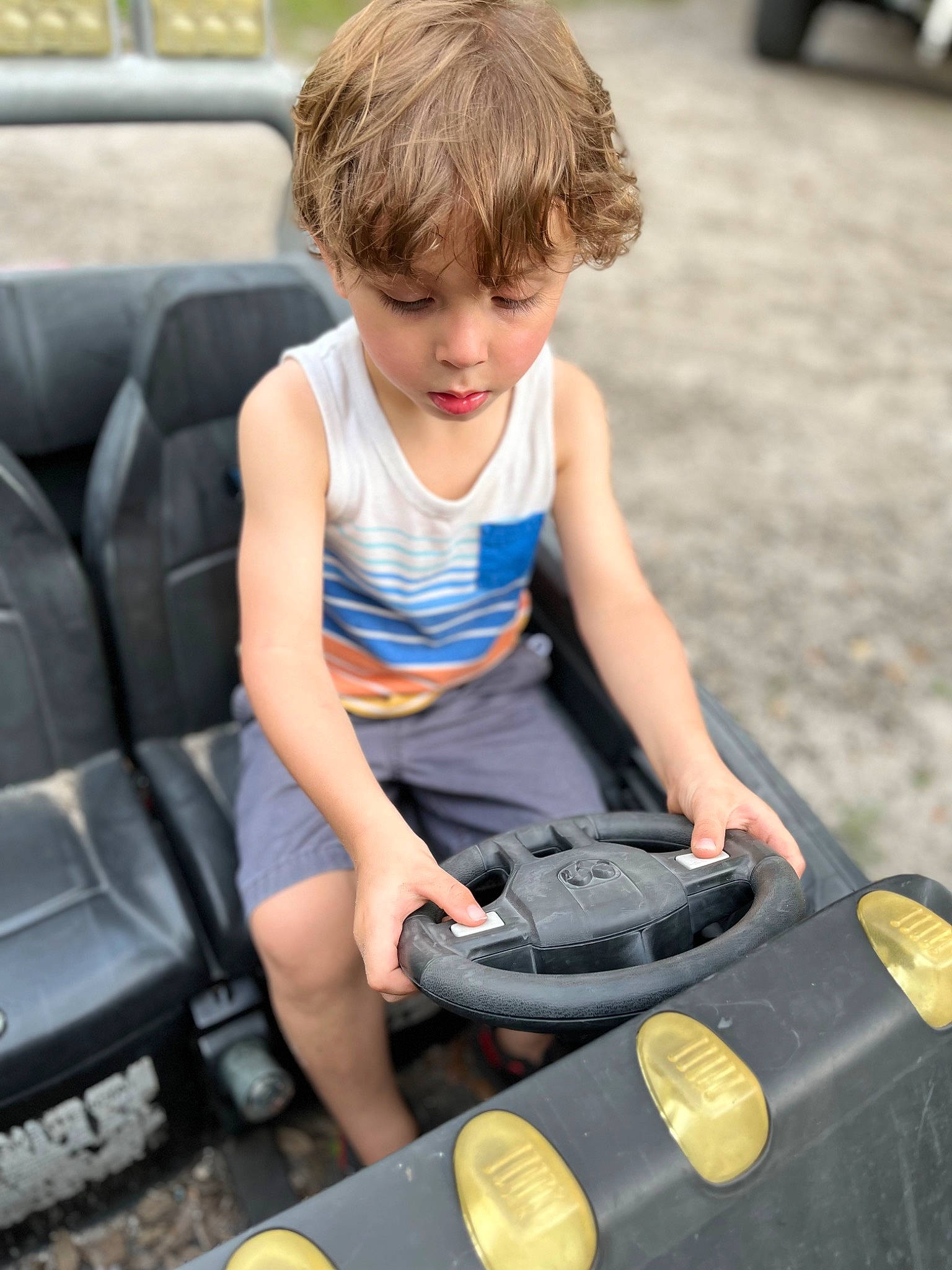 Dustin is registered to the contest to win money with this photo: automotive_design, automotive_exterior, bag, blond, bumper, child, electric_blue, face, fun, hair, human_leg, leisure, luggage_and_bags, motor_vehicle, person, shorts, sitting, t_shirt, toddler, travel