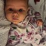 Ivy Mae is registered to the contest to win money with this photo: baby, infant, face, eyes, blanket, pacifier, onesie, floral, sleepwear, soft, cute, lying_down, skin, hand, expression, indoors, child, newborn, comfort, resting