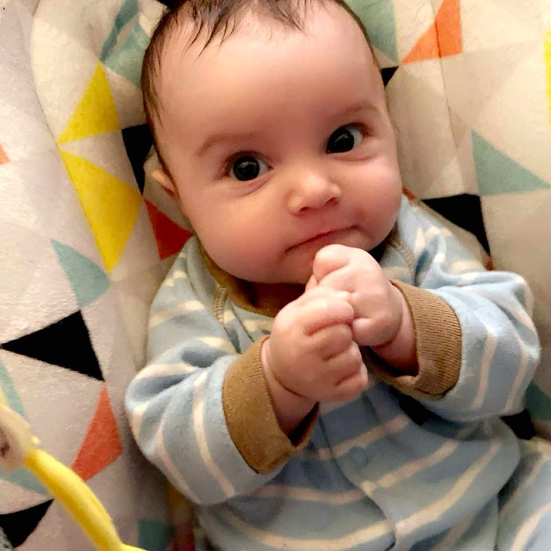 Zayden is registered to the contest to win money with this photo: baby, bed, blanket, bodypart, clothing, cutlery, face, finger, furniture, hand, hat, head, newborn, pants, person, photography, portrait, quilt, spoon, toy