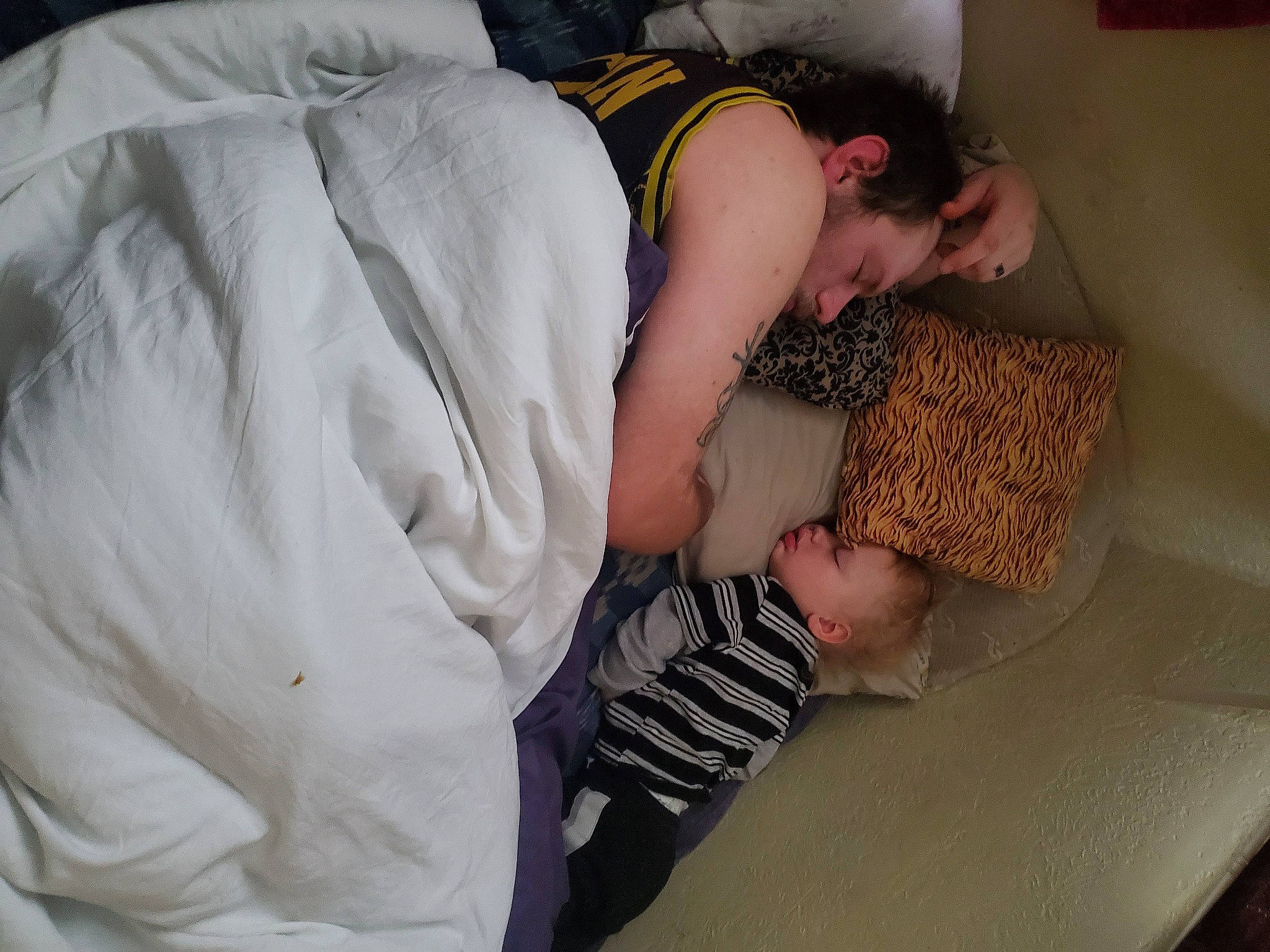 Lachlan joined the competition — help win amazing prizes! baby, bedding, child, comfort, elbow, flooring, fun, gesture, human_body, human_leg, linens, nap, pattern, person, pillow, room, sitting, t_shirt, thigh, throw_pillow