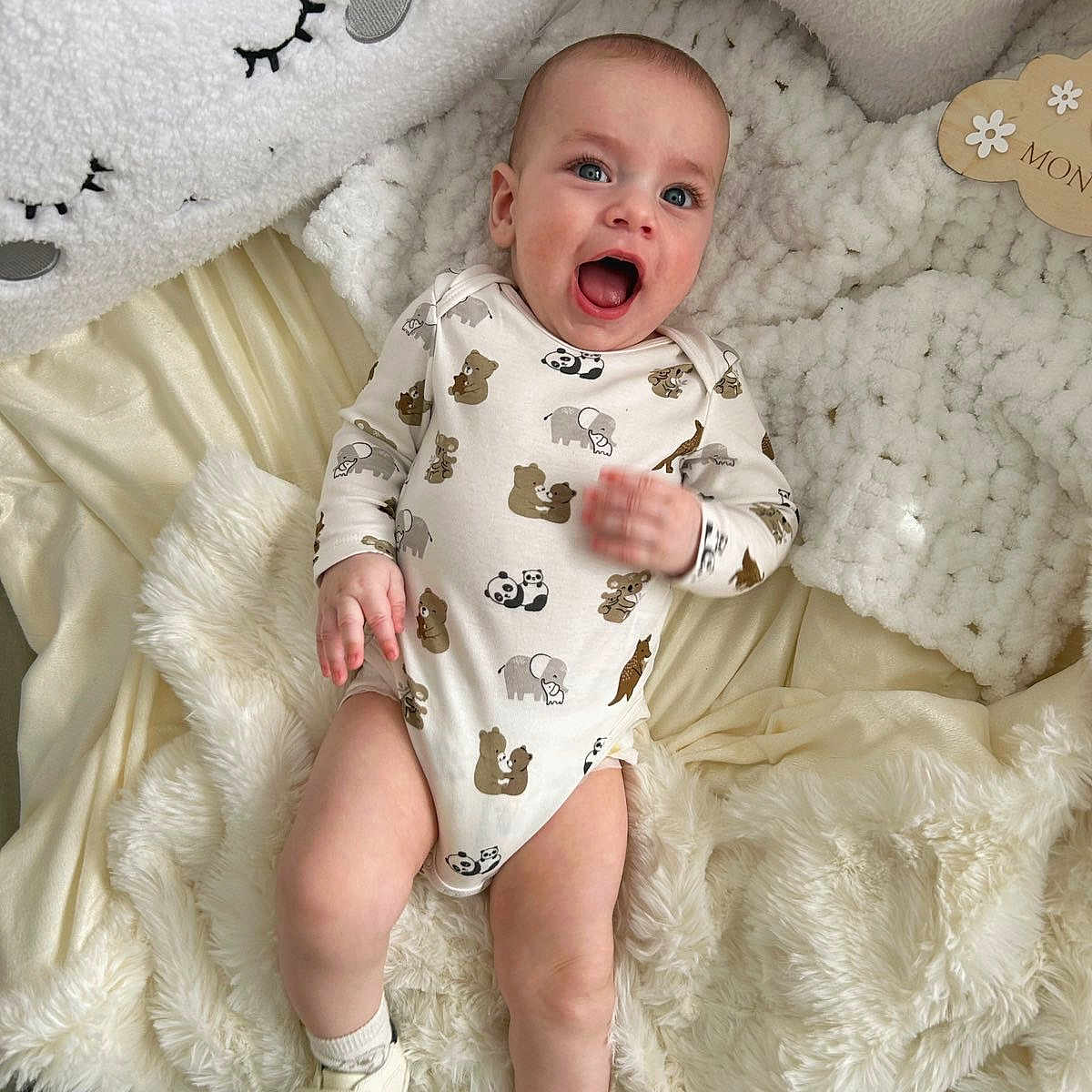 Damian participe au concours pour gagner de l'argent avec cette photo : baby, infant, smiling, onesie, animal_print, blue_eyes, white_blanket, fluffy, pillows, star_pillow, soft_toys, socks, shoes, lying_down, cute, happy, indoor, child, portrait, cozy