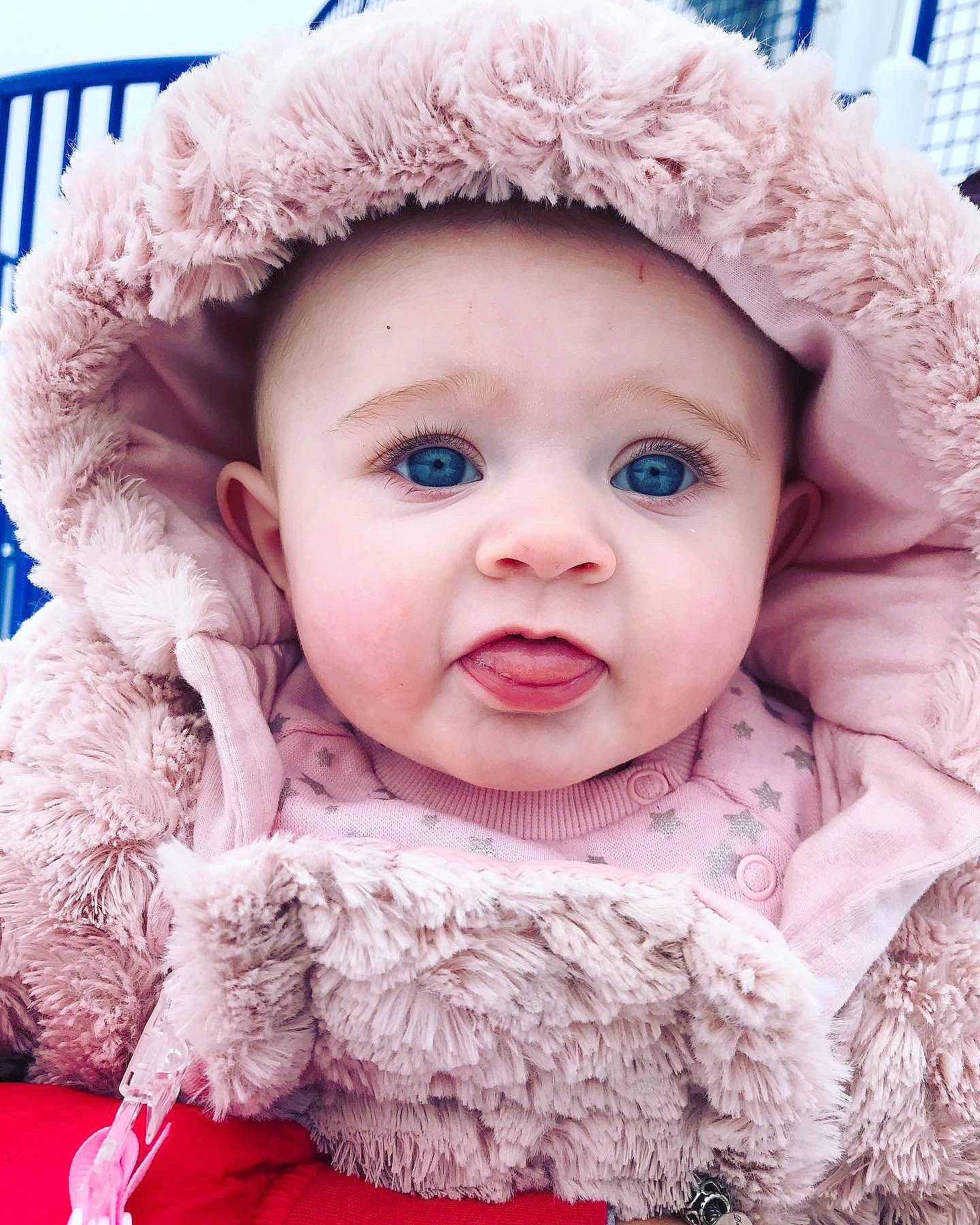 Lexie joined the competition — help win amazing prizes! baby_toddler_clothing, cap, cheek, chin, eye, eyebrow, facial_expression, fur_clothing, happy, headwear, iris, lip, mouth, nose, organ, outerwear, person, pink, skin, sleeve