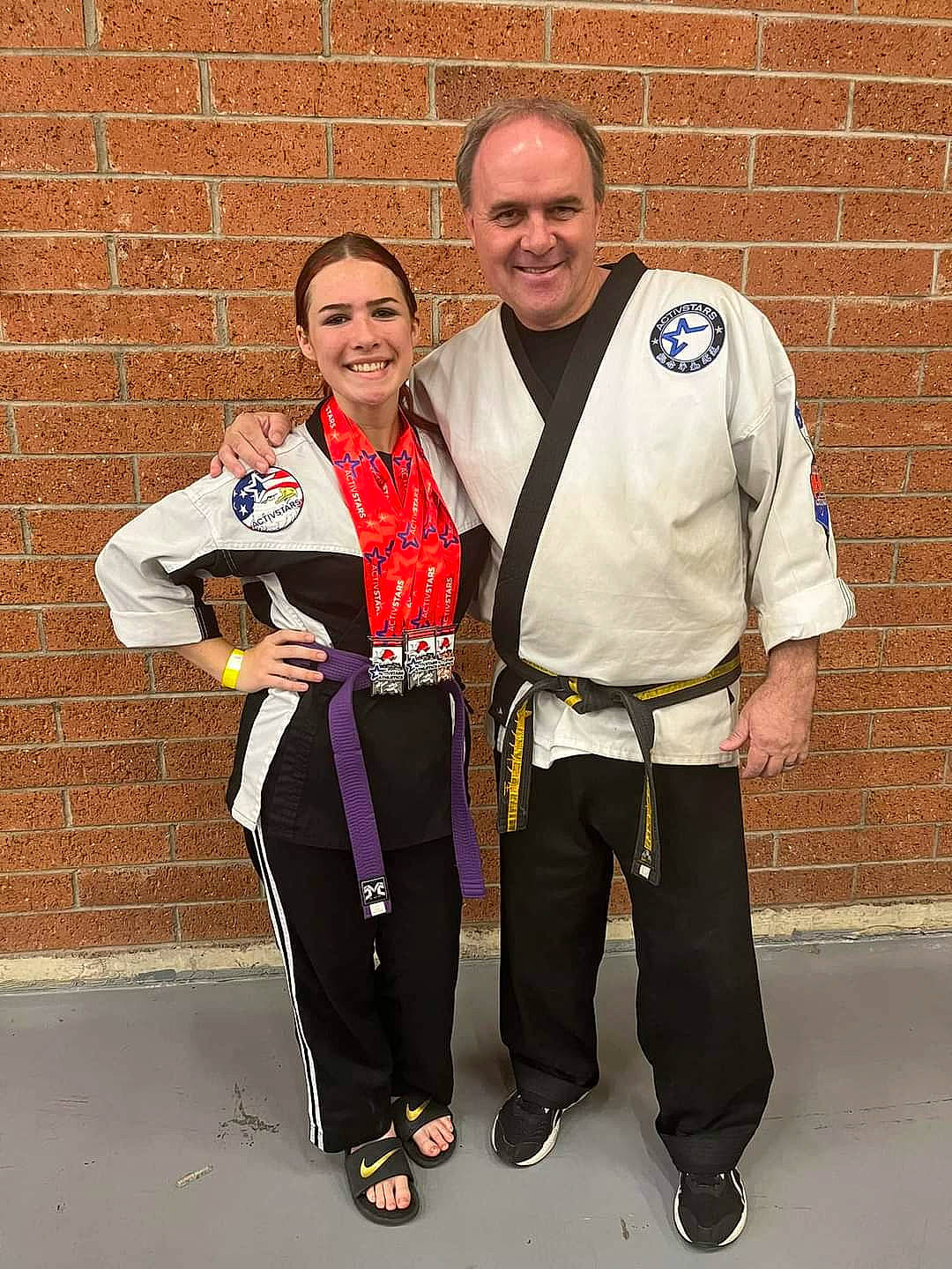 Amethyst is registered to the contest to win money with this photo: award, belt, brick, brickwork, bronze_medal, championship, competition_event, event, joy, medal, official, person, player, recreation, silver_medal, smile, sports, sports_uniform, sportswear, sweatpant