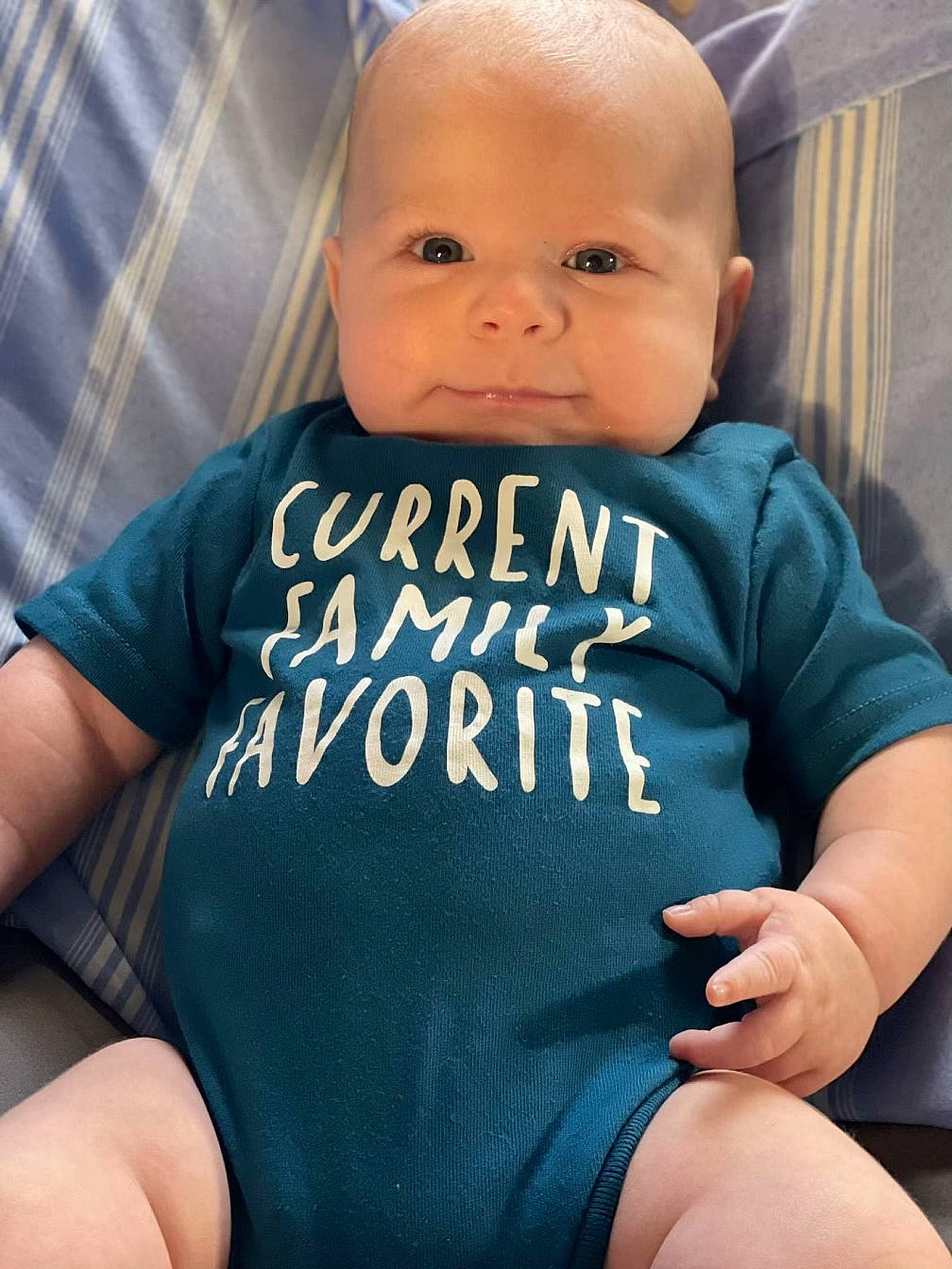 Archer is registered to the contest to win money with this photo: azure, baby, baby_toddler_clothing, comfort, eye, finger, gesture, hairstyle, hand, happy, human_body, joint, leg, muscle, neck, nose, organ, person, shoulder, skin