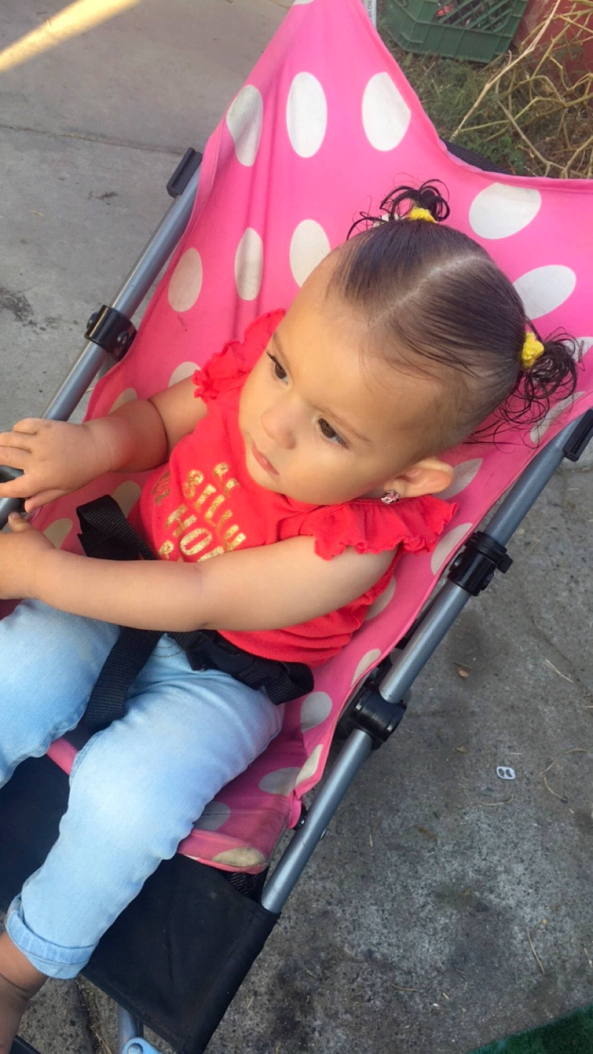 Maya is registered to the contest to win money with this photo: auto_part, baby, baby_carriage, baby_products, baby_toddler_clothing, chair, child, comfort, eye, fun, grass, lap, leisure, magenta, person, pink, plant, product, skin, toddler