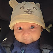 Noah joined the competition — help win amazing prizes! baby, child, hat, bear_ears, car_seat, seatbelt, blue_sweater, blanket, face, eyes, cute, infant, smile, clothing, portrait, indoors, closeup, baby_accessory, warm, child_seat