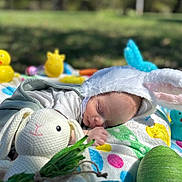 Levin joined the competition — help win amazing prizes! baby, bunny_ears, sleeping, blanket, outdoor, grass, toy, knitted_bunny, rubber_duck, colorful, cute, child, peaceful, easter, playful, infant, nature, soft, nap, spring