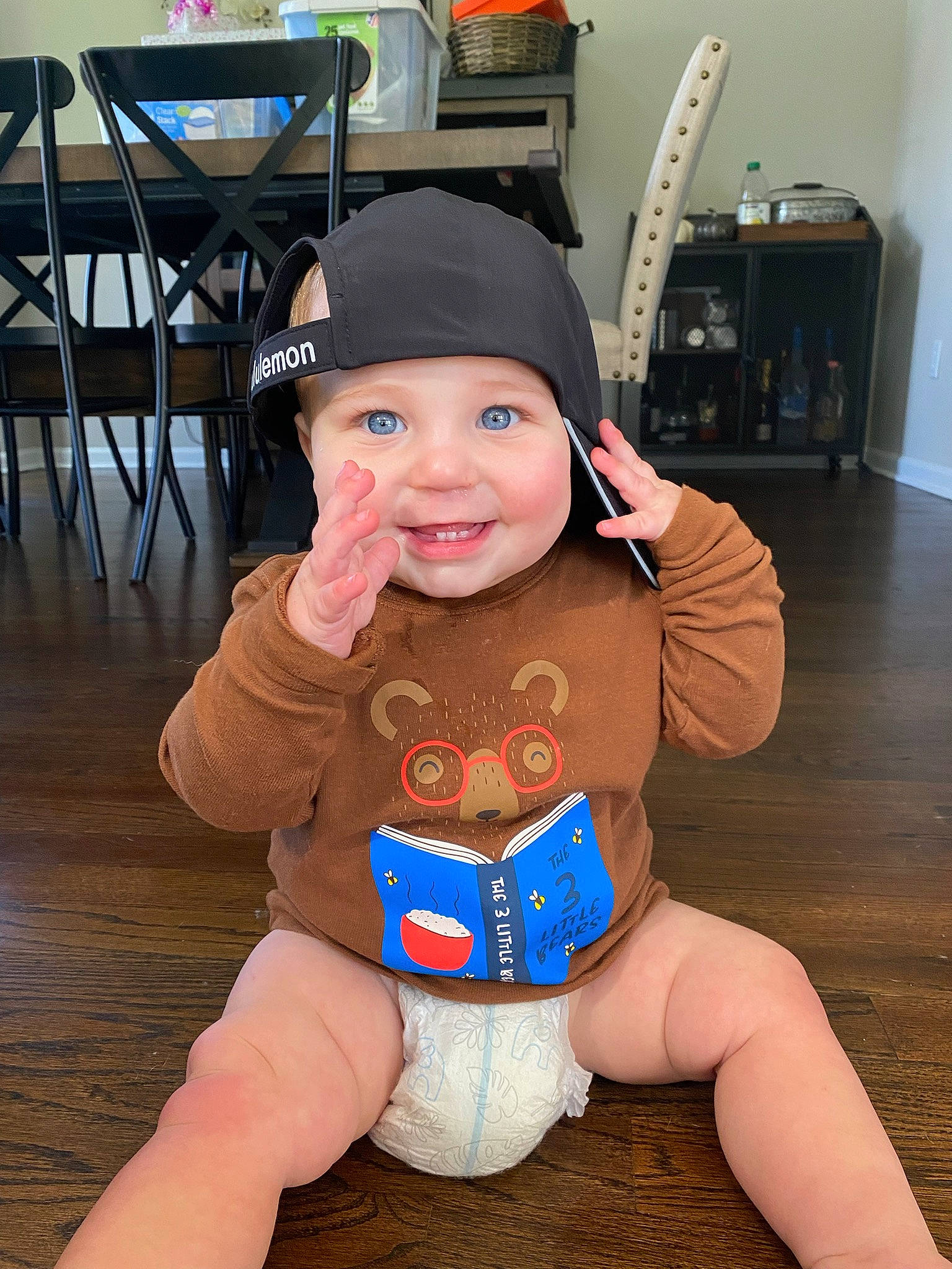 Cole is registered to the contest to win money with this photo: baby, baby_toddler_clothing, cap, electric_blue, eye, face, flooring, foot, fun, happy, headwear, human_body, human_leg, knee, mouth, person, personal_protective_equipment, skin, smile, thigh