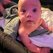 Xander joined the competition — help win amazing prizes! baby, infant, child, face, portrait, wide_eyes, indoor, blanket, bed, crawling, sitting, skin, arms, legs, feet, cozy, home, close_up, soft_lighting, photography
