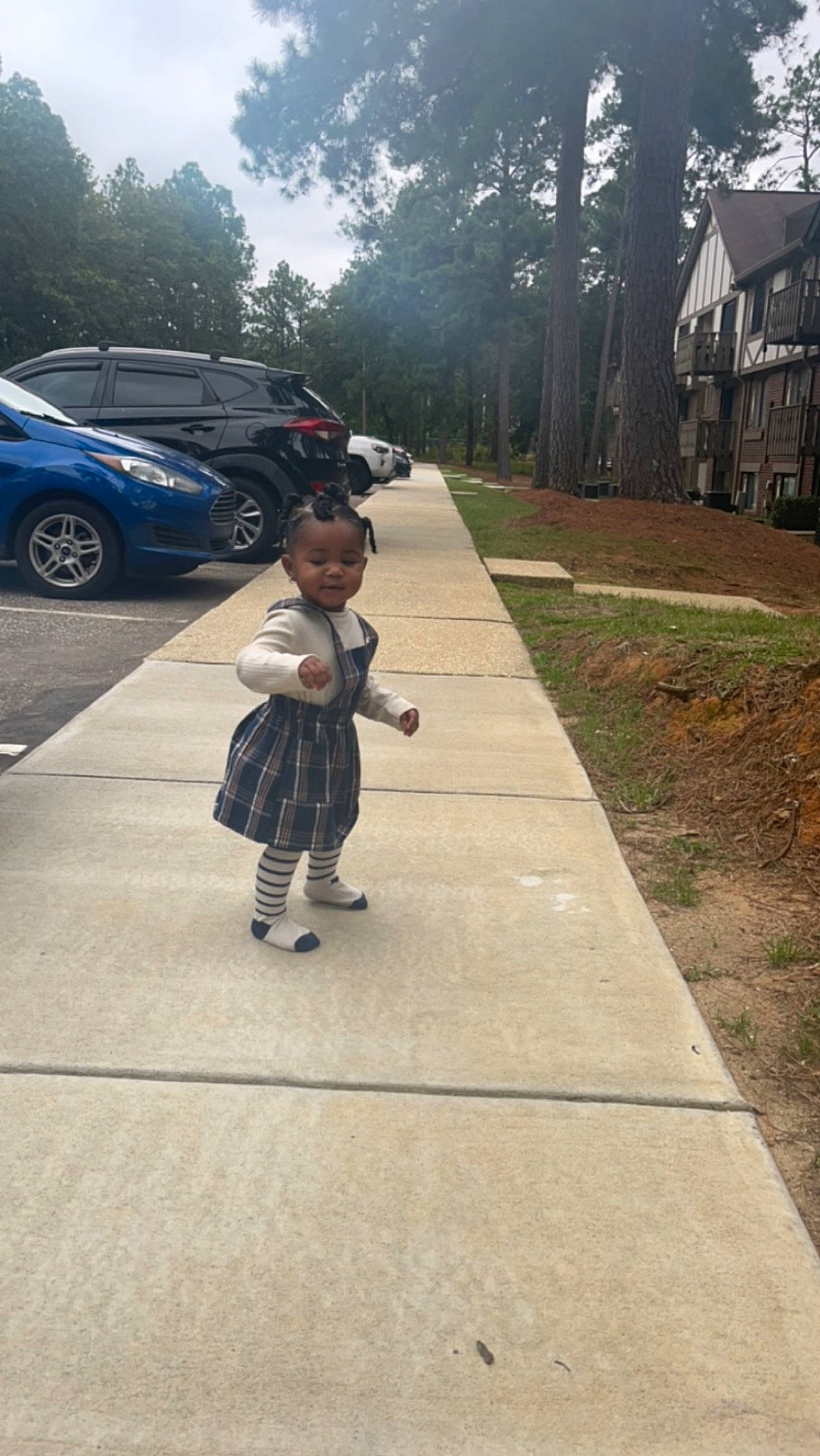 Harmony is registered to the contest to win money with this photo: asphalt, car, child, family_car, land_vehicle, motor_vehicle, pedestrian, person, plant, recreation, road, road_surface, sidewalk, sky, tire, toddler, travel, tree, vehicle, vehicle_door