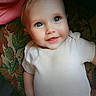 Luna joined the competition — help win amazing prizes! baby, child, infant, smiling, portrait, indoors, couch, blanket, white_shirt, blue_eyes, face, head, arms, seated, lying_down, cozy, patterned_fabric, pink, date_stamp, photography