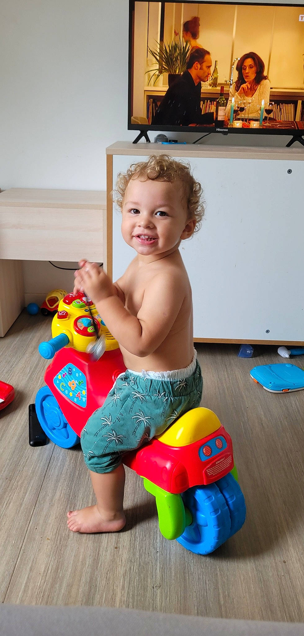 Noham a rejoint le concours — aidez-le/la à gagner de superbes lots ! baby, baby_playing_with_toys, baby_toys, blue, child, flooring, fun, happy, home_appliance, human_leg, joy, leisure, person, picture_frame, plastic, play, room, sitting, smile, television