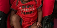 Skylan joined the competition — help win amazing prizes! baby, black, car_seat, child, clothing, cute, expression, face, foot, hand, indoors, infant, onesie, person, portrait, red, seat, sitting, warning_label, young_child