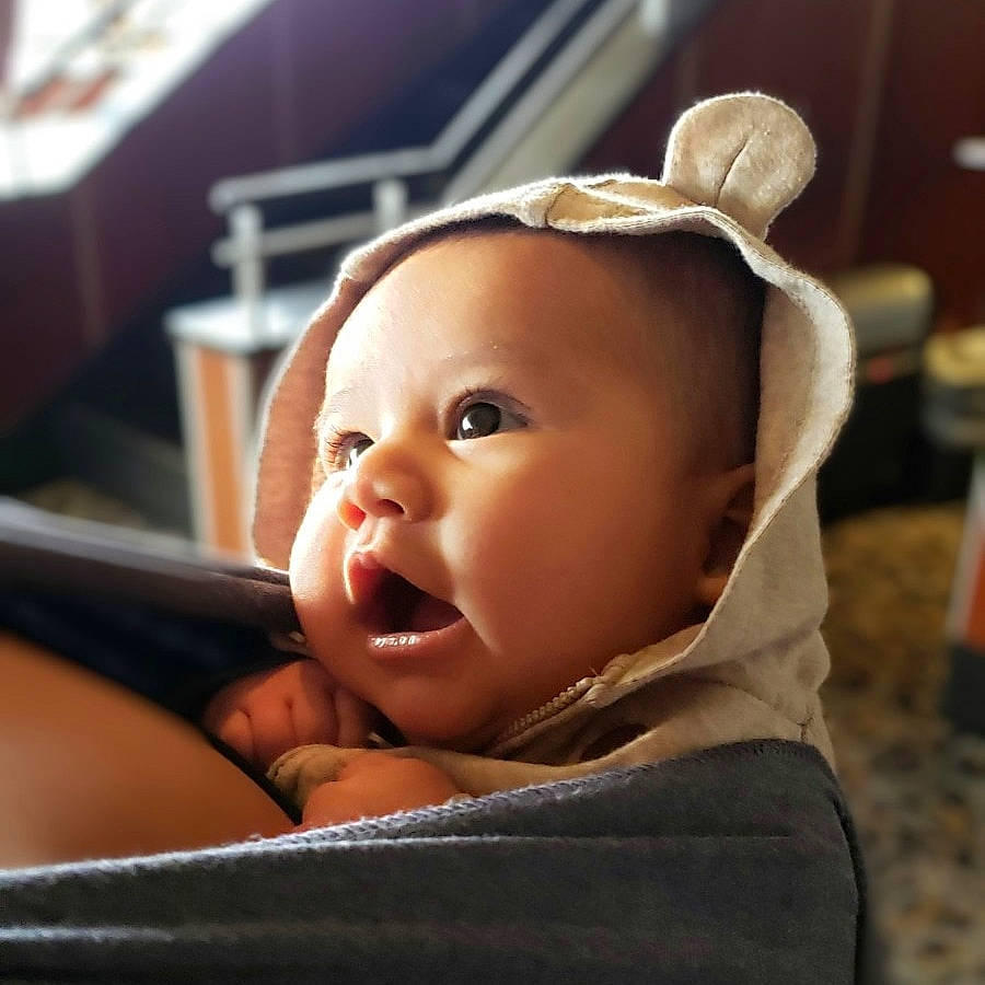 Lucius is registered to the contest to win money with this photo: baby, baby_toddler_clothing, cheek, child, comfort, ear, eyebrow, eyelash, fashion_accessory, flash_photography, fun, happy, human_body, iris, lip, nose, person, portrait_photography, sitting, smile