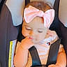 Neda is registered to the contest to win money with this photo: baby, child, infant, car_seat, seatbelt, harness, pink_bow, bow, baby_clothing, sitting, portrait, face, eyes, hand, finger, indoors, vehicle, safety, cute, photography