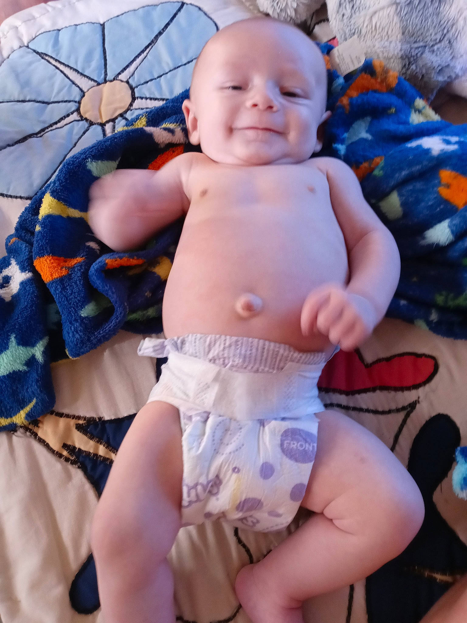 Legend is registered to the contest to win money with this photo: abdomen, baby, barechested, blue, chest, child, eye, happy, human_body, leisure, navel, person, shorts, skin, smile, stomach, thigh, toddler, trunk, umbrella