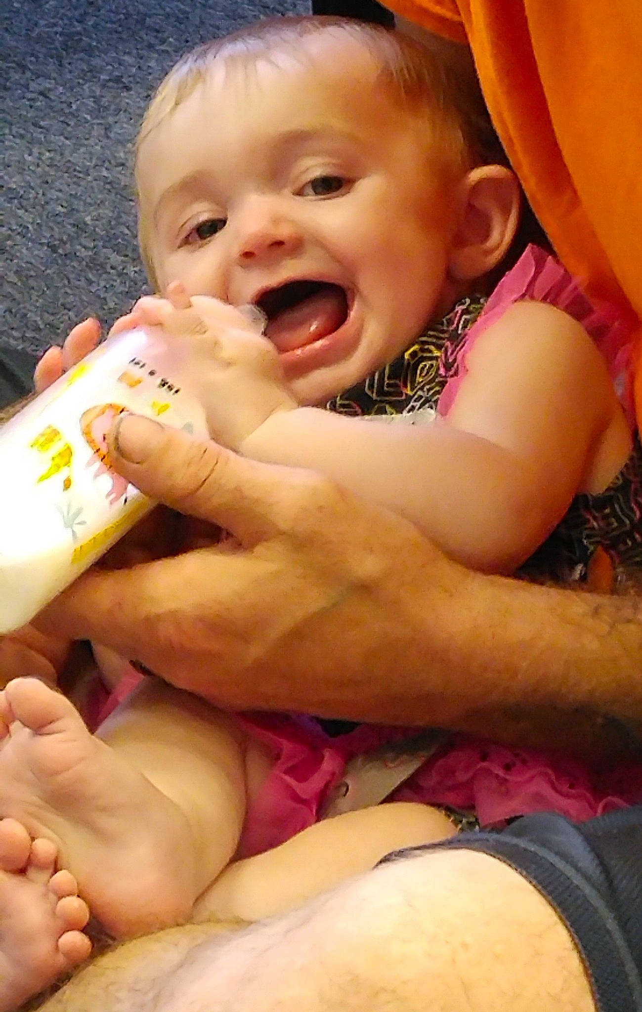 Heaven is registered to the contest to win money with this photo: arm, baby, baby_bottle, baby_toddler_clothing, cheek, child, finger, gesture, hand, happy, lip, mouth, nail, nose, organ, person, pink, skin, smile, toddler