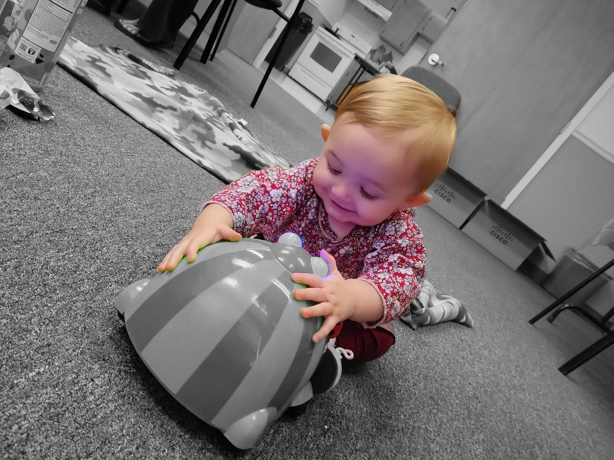 Heaven is registered to the contest to win money with this photo: automotive_design, baby, carmine, carpet, chair, child, comfort, floor, flooring, fun, grass, hardwood, mammal, person, personal_protective_equipment, room, sitting, smile, sports_gear, toddler