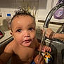 baby, infant, child, sink, kitchen_sink, faucet, water, wet_hair, bath, toy, playing, hand, soap_bottle, tiles, window, countertop, closeup, portrait, expression, splash