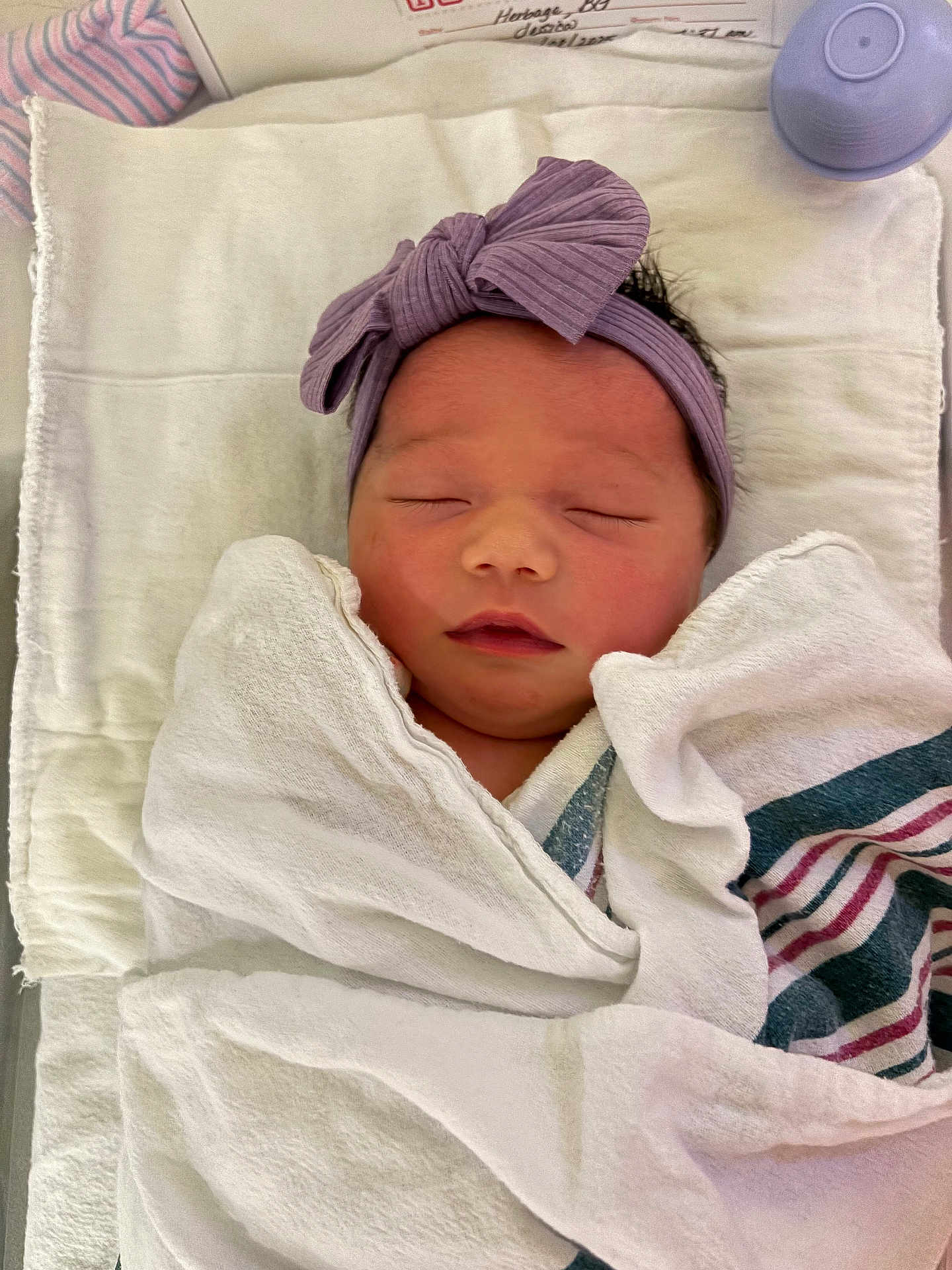 Francesca joined the competition — help win amazing prizes! newborn, baby, sleeping, wrapped, blanket, headband, purple, bow, peaceful, infant, swaddled, soft, cute, resting, towel, striped_blanket, indoors, closeup, person, child