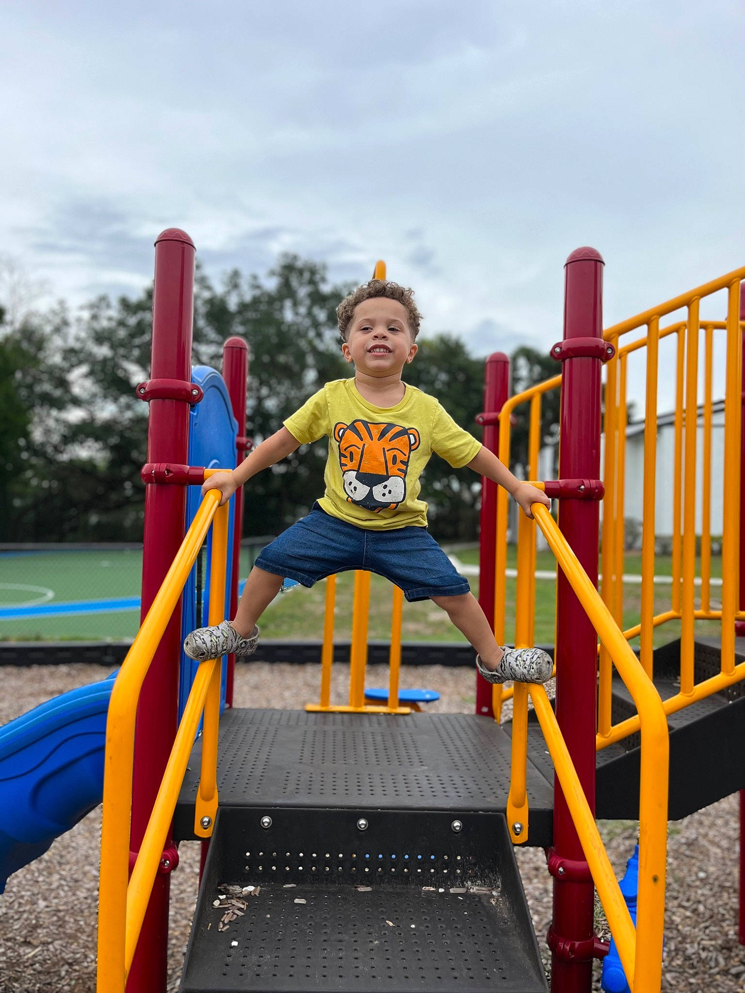Dakari is registered to the contest to win money with this photo: baby_toddler_clothing, child, chute, city, cloud, electric_blue, fun, joy, leisure, nonbuilding_structure, outdoor_play_equipment, outdoor_recreation, person, play, playground, recreation, shorts, sky, sleeve, smile