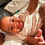 Leeonnie is registered to the contest to win money with this photo: baby, smile, person, infant, clothing, heart_pattern, hand, adult, bed, blanket, indoor, portrait, joy, skin, face, candid, happy, family, toddler, closeup