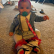 Leeonnie is registered to the contest to win money with this photo: baby, child, pacifier, denim_jacket, headband, flower, sneakers, carpet, indoor, smiling, cute, purse, red, white, person, floor, happy, young_child, clothing, accessories