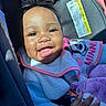 Levyn is registered to the contest to win money with this photo: baby, smiling, child, infant, car_seat, plush_toy, bib, clothing, headband, happy, cute, indoors, sunlight, portrait, person, skin, hand, closeup, face, cozy