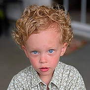 Milo is registered to the contest to win money with this photo: child, boy, curly_hair, blonde, blue_eyes, portrait, close_up, shirt, floral_pattern, face, young, looking, indoor, soft_light, skin, expression, cute, innocent, childhood, person