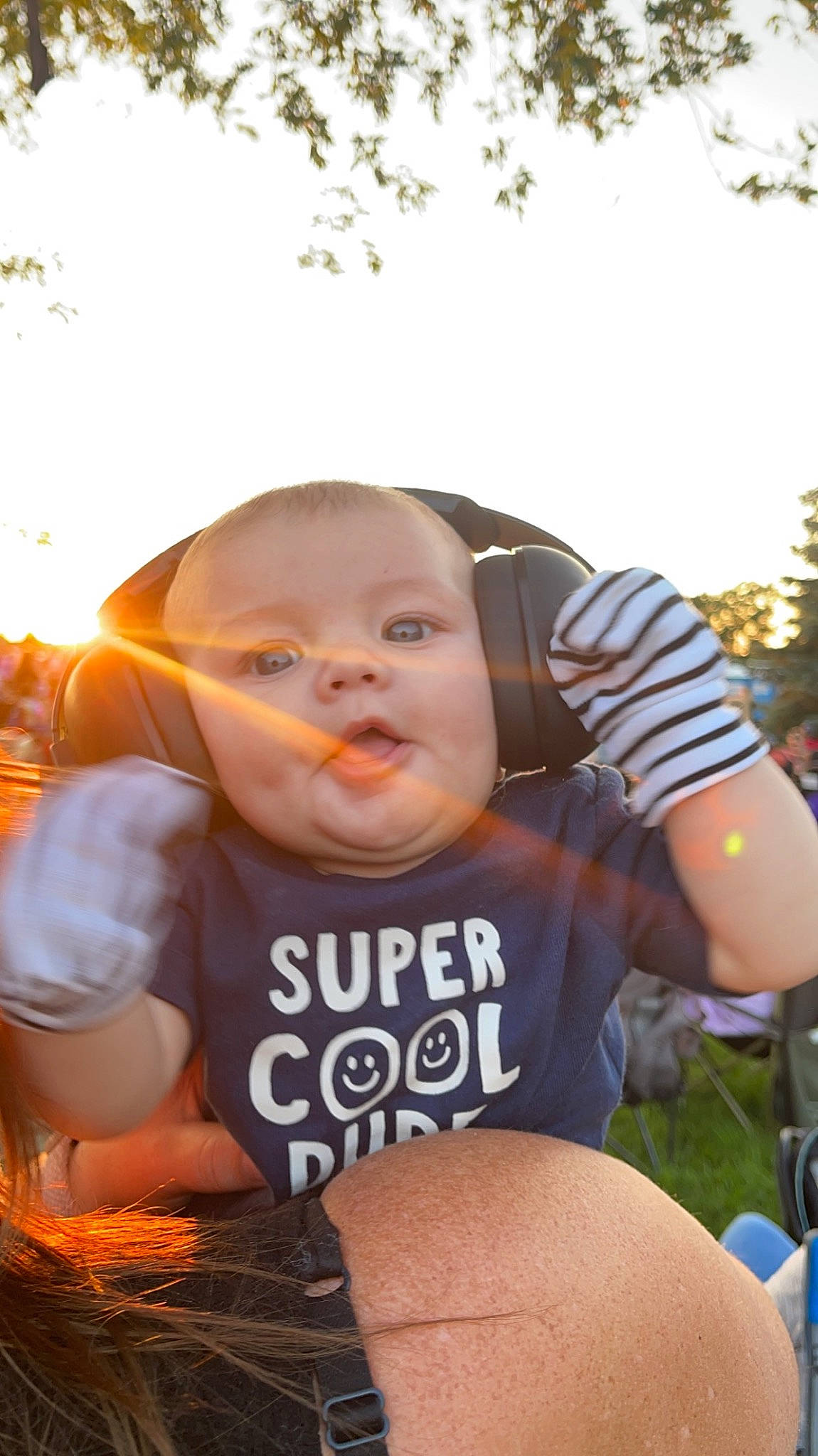 Kane is registered to the contest to win money with this photo: baby, child, eyewear, finger, flash_photography, fun, grass, happy, leaf, leisure, people_in_nature, person, personal_protective_equipment, plant, recreation, sitting, sky, soil, t_shirt, toddler