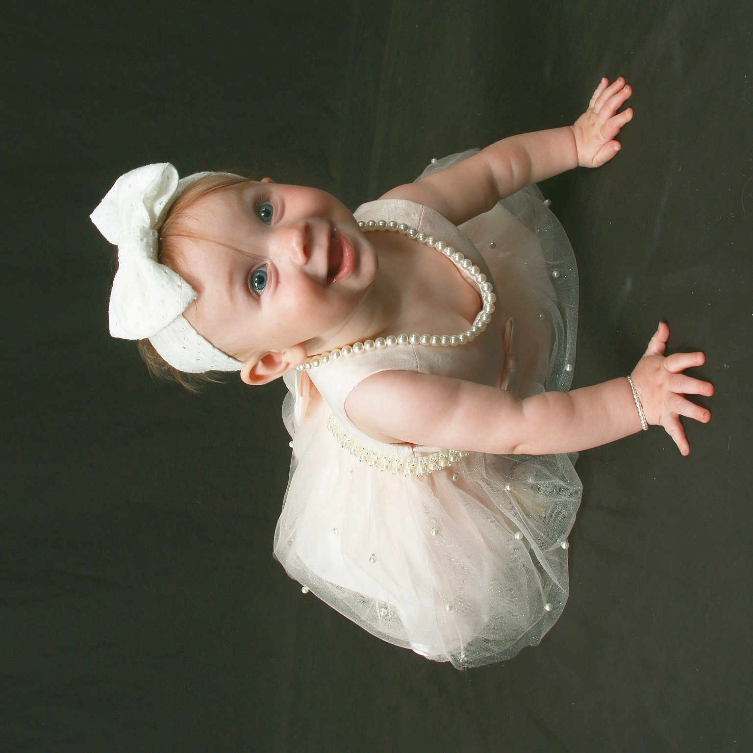Aislyn is registered to the contest to win money with this photo: baby, blue_eyes, bow, bracelet, celebration, child, crawling, cute, elegant, fashion, girl, happy, headband, infant, joyful, pearl_necklace, portrait, smiling, studio, tutu_dress