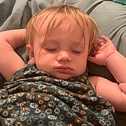 Aislyn is registered to the contest to win money with this photo: toddler, sleeping, child, blonde_hair, floral_dress, blanket, bedroom, cozy, peaceful, arms_up, face, indoors, soft_lighting, furniture, cute, resting, young_child, portrait, relaxation, home